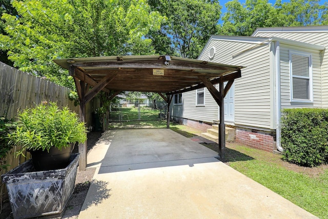 831 Jackman St, Benton, AR 72015 - view of parking featuring driveway, entry steps, and a carport