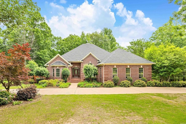 15680 Spring Club Dr, Hensley, AR 72065 - view of front of house with brick siding, a front yard, and a shingled roof