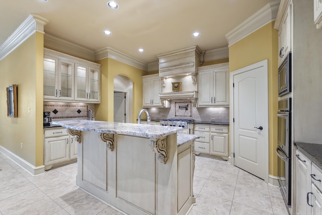 1606 Hilldale, Alexander, AR 72002 - kitchen with arched walkways, a breakfast bar area, decorative backsplash, recessed lighting, and light stone countertops