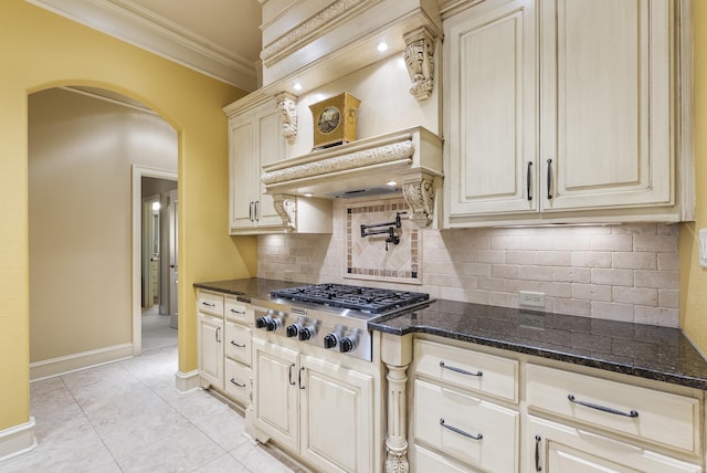 1606 Hilldale, Alexander, AR 72002 - kitchen featuring stainless steel gas stovetop, arched walkways, crown molding, tasteful backsplash, and dark stone countertops