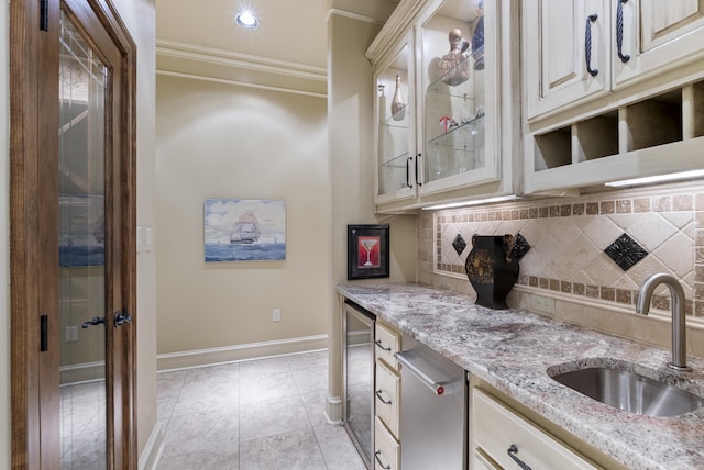 1606 Hilldale, Alexander, AR 72002 - kitchen featuring a sink, crown molding, wine cooler, decorative backsplash, and cream cabinetry
