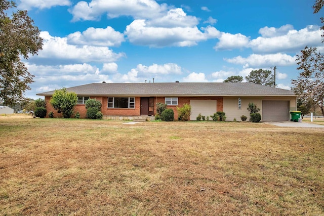 ranch-style house featuring a garage, a front lawn, concrete driveway, and brick siding