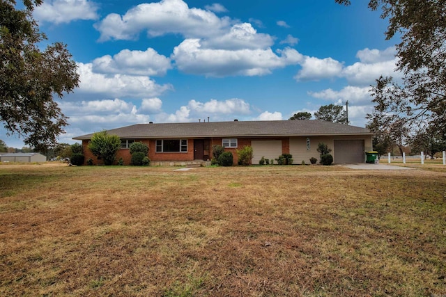 ranch-style home featuring a garage and driveway