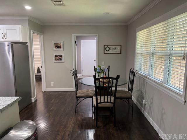 2012 Paula St, Pocahontas, AR 72455 - dining area with dark wood-style flooring, baseboards, and crown molding