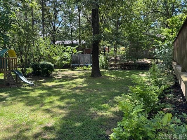 2012 Paula St, Pocahontas, AR 72455 - view of grassy yard with a trampoline and a playground