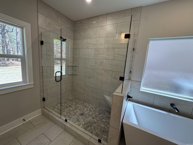 1114 Grand Teton, Benton, AR 72019 - bathroom with a freestanding tub, a shower stall, baseboards, tile patterned flooring, and a sink