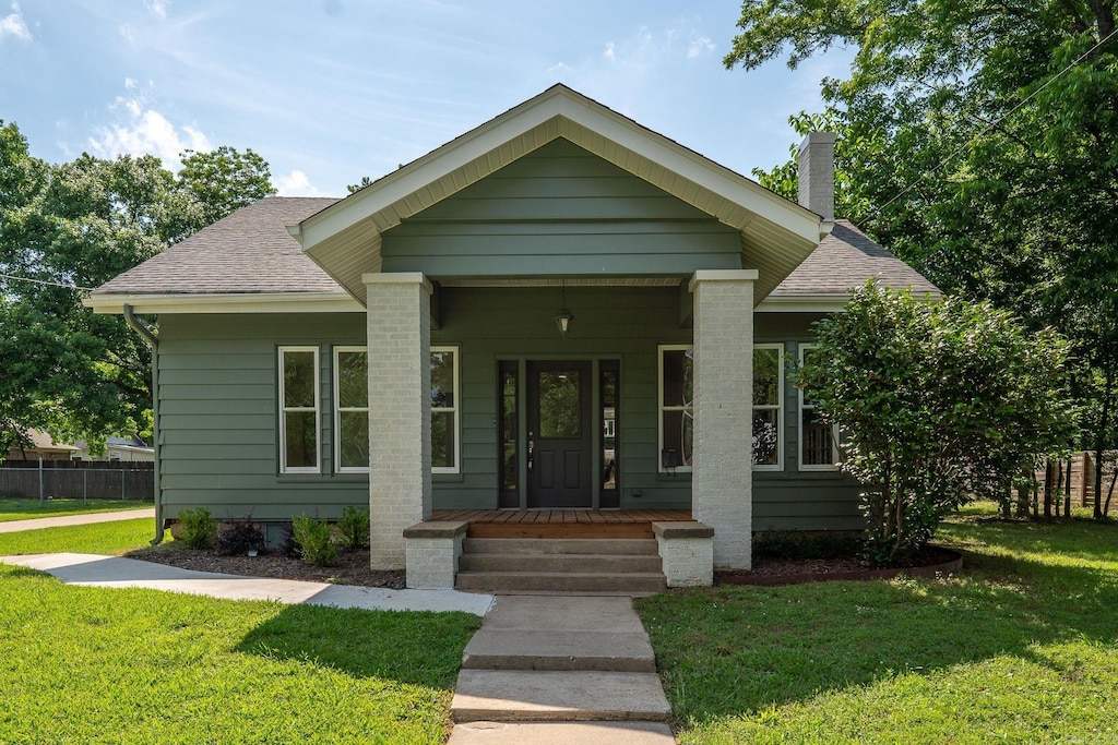 315 Locust, Conway, AR 72034 - view of front facade featuring a shingled roof, covered porch, and a chimney