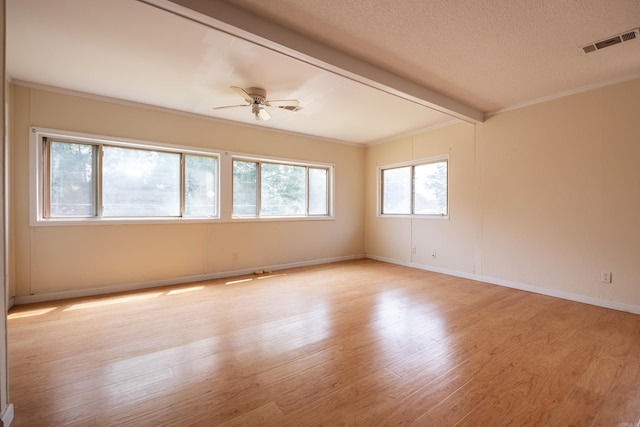 1411 Maple St, North Little Rock, AR 72114 - empty room with a ceiling fan, light wood finished floors, beam ceiling, a textured ceiling, and baseboards