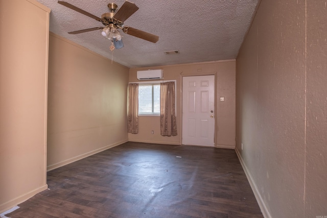 1411 Maple St, North Little Rock, AR 72114 - empty room with a wall unit AC, wood finished floors, a textured ceiling, ceiling fan, and baseboards