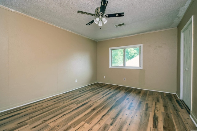 1411 Maple St, North Little Rock, AR 72114 - unfurnished bedroom with wood finished floors, a textured ceiling, baseboards, ornamental molding, and ceiling fan