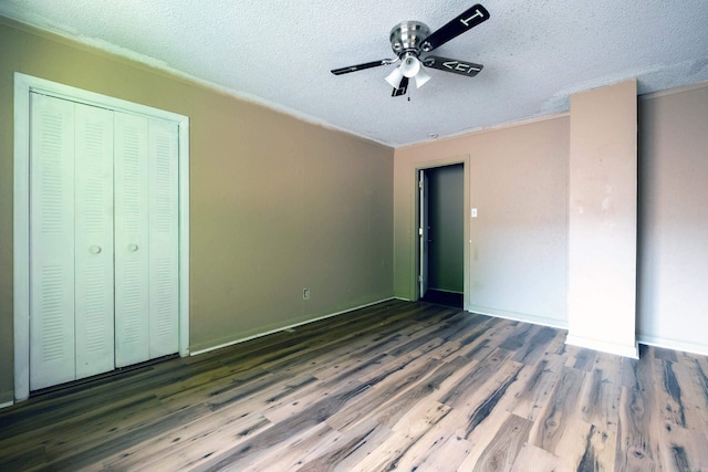 1411 Maple St, North Little Rock, AR 72114 - unfurnished bedroom featuring a textured ceiling, wood finished floors, a closet, and ceiling fan