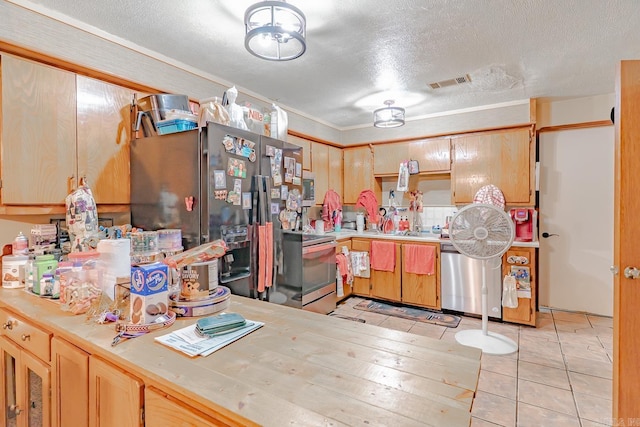 612 E E St, Russellville, AR 72801 - kitchen featuring stainless steel appliances, light countertops, a textured ceiling, and light tile patterned flooring