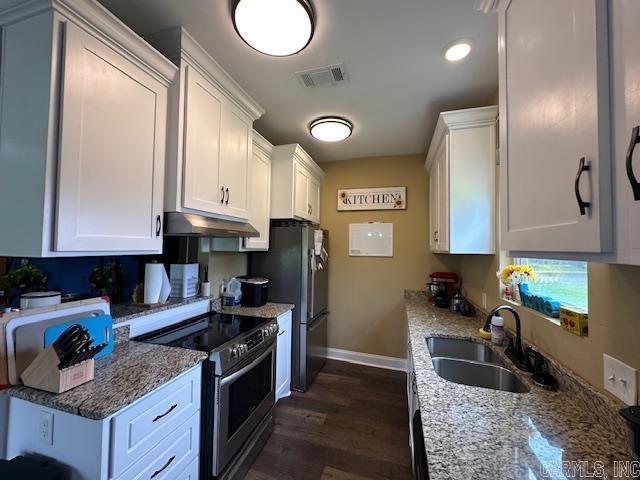 1415 Ben St, North Little Rock, AR 72117 - kitchen featuring appliances with stainless steel finishes, a sink, under cabinet range hood, baseboards, and white cabinets