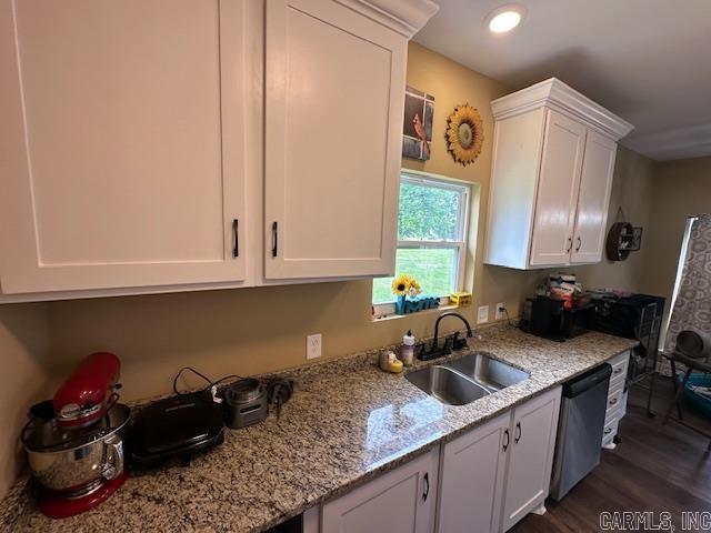 1415 Ben St, North Little Rock, AR 72117 - kitchen featuring a sink, stainless steel dishwasher, white cabinetry, dark wood-style flooring, and light stone countertops
