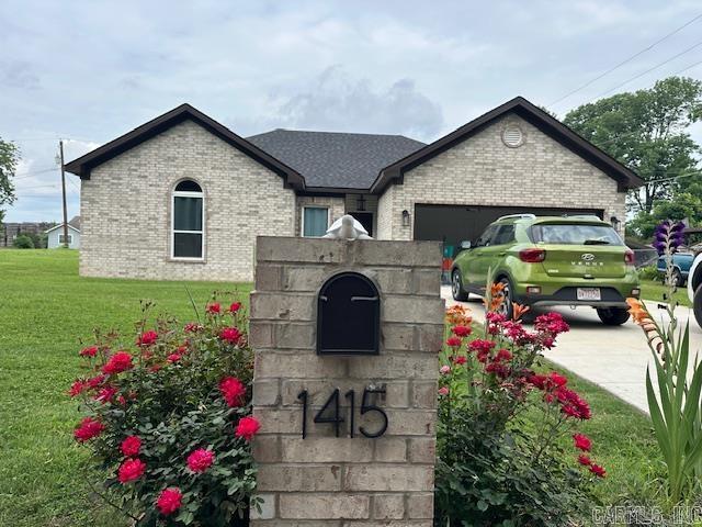 1415 Ben St, North Little Rock, AR 72117 - exterior view of brick siding and driveway
