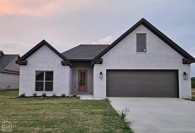 125 Hidden Creek Dr, Brookland, AR 72417 - view of front of home with brick siding, concrete driveway, and a front yard