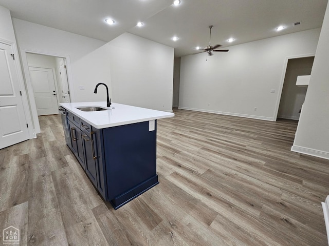 125 Hidden Creek Dr, Brookland, AR 72417 - kitchen with a sink, blue cabinetry, light wood finished floors, light countertops, and recessed lighting