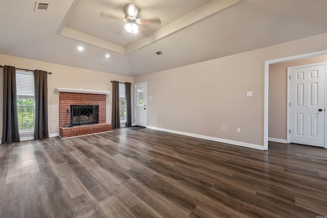 15 Diamond Dr, Cabot, AR 72023 - unfurnished living room featuring a tray ceiling, ceiling fan, dark wood-style flooring, recessed lighting, and a brick fireplace