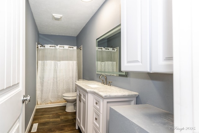 46 Hillcrest Rd, Mammoth Spring, AR 72554 - full bathroom featuring toilet, vanity, wood finished floors, baseboards, and a shower with curtain