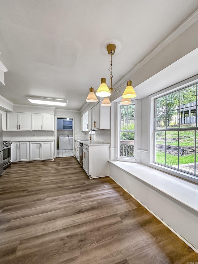 23 Morrison Ct, Little Rock, AR 72212 - kitchen featuring washing machine and dryer, a sink, stainless steel appliances, light countertops, and dark wood finished floors