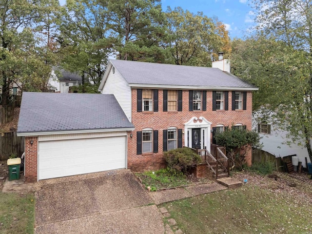 23 Morrison Ct, Little Rock, AR 72212 - colonial home featuring a chimney, a garage, brick siding, and concrete driveway