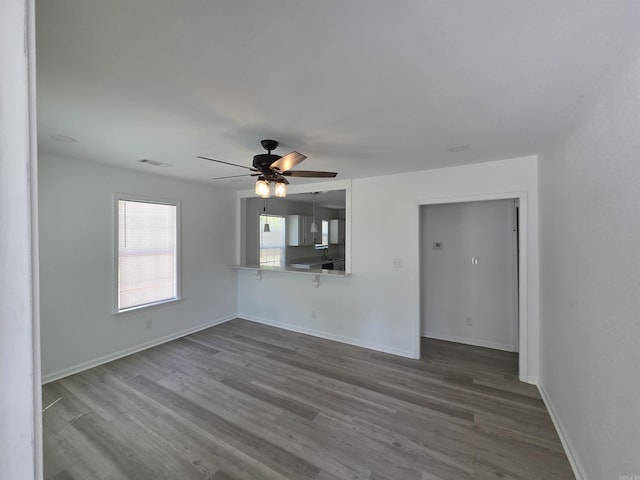 4518 W 25th, Little Rock, AR 72204 - unfurnished living room with a ceiling fan, dark wood finished floors, and baseboards