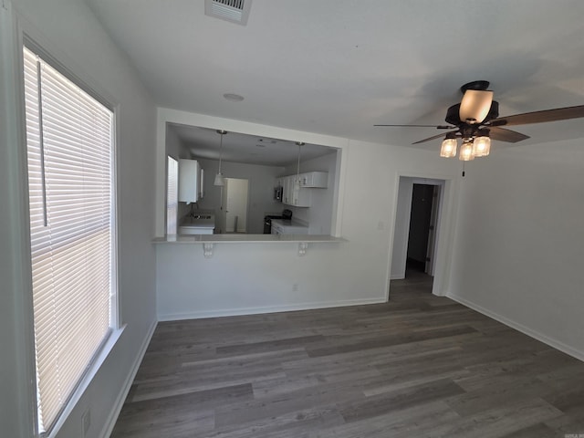 4518 W 25th, Little Rock, AR 72204 - unfurnished living room with a ceiling fan, dark wood-type flooring, and baseboards