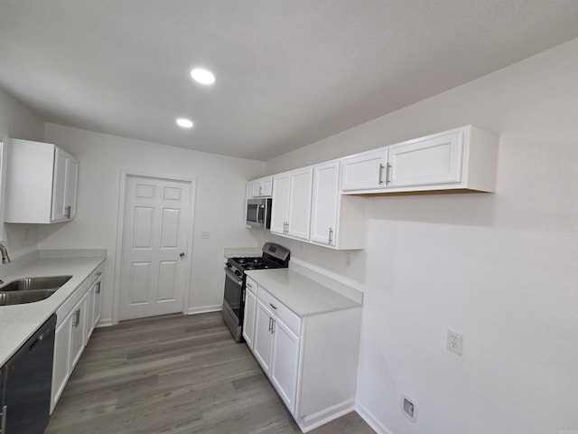 4518 W 25th, Little Rock, AR 72204 - kitchen featuring stainless steel appliances, a sink, white cabinets, light countertops, and baseboards