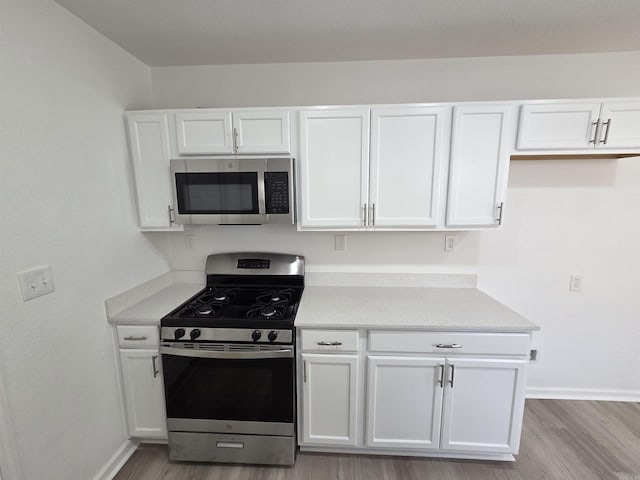 4518 W 25th, Little Rock, AR 72204 - kitchen with appliances with stainless steel finishes, baseboards, and white cabinetry