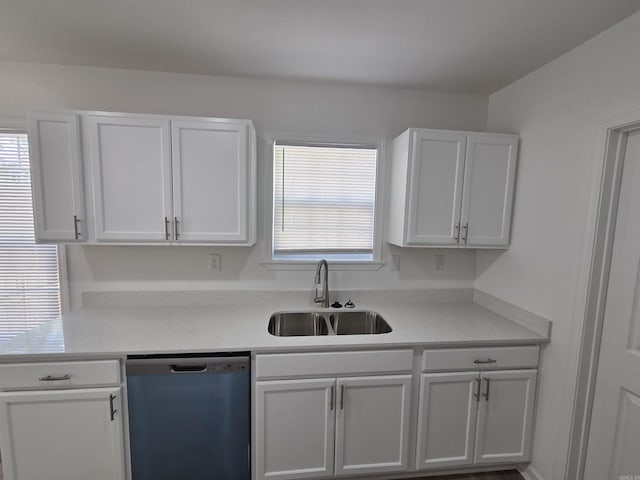 4518 W 25th, Little Rock, AR 72204 - kitchen with dishwashing machine, a sink, light countertops, and white cabinets
