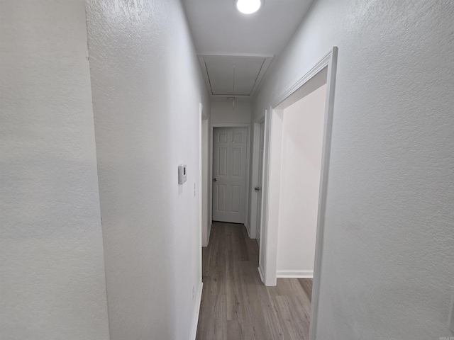 4518 W 25th, Little Rock, AR 72204 - corridor with attic access, wood finished floors, a textured wall, and baseboards