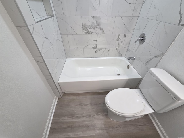 4518 W 25th, Little Rock, AR 72204 - full bathroom featuring wood finished floors, toilet, baseboards, a textured wall, and washtub / shower combination