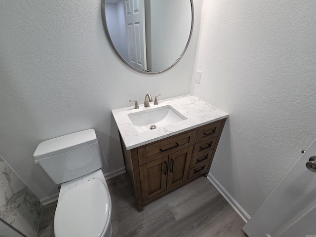 4518 W 25th, Little Rock, AR 72204 - half bathroom featuring vanity, toilet, wood finished floors, baseboards, and a textured wall
