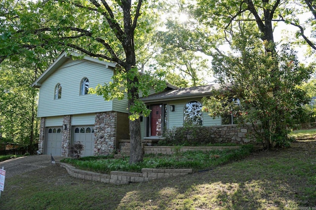 2318 Breckenridge Dr, Little Rock, AR 72227 - tri-level home featuring stone siding, driveway, and an attached garage