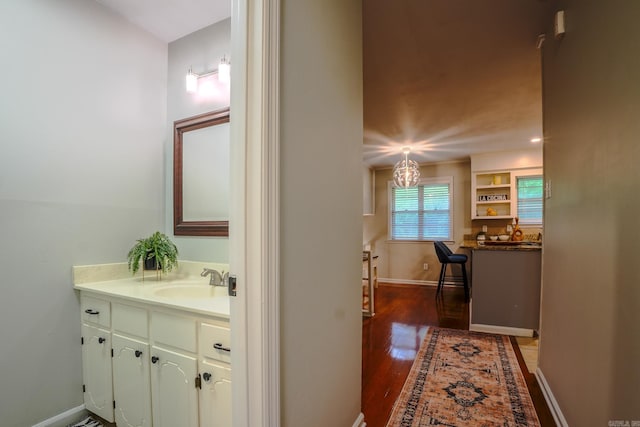 2318 Breckenridge Dr, Little Rock, AR 72227 - bathroom with vanity, wood finished floors, and baseboards