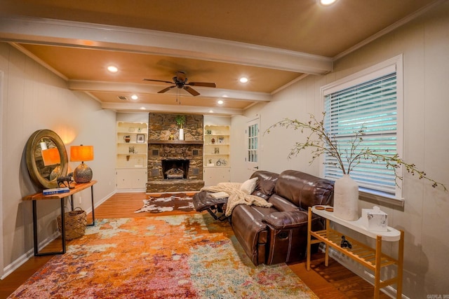 2318 Breckenridge Dr, Little Rock, AR 72227 - living area featuring beam ceiling, wood finished floors, ceiling fan, ornamental molding, and a stone fireplace