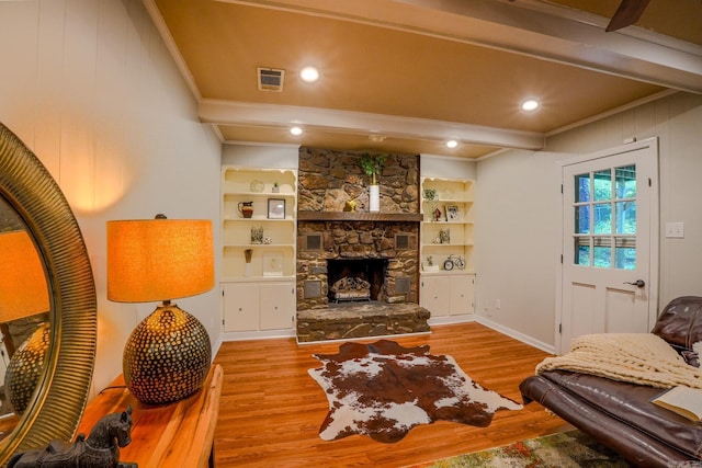2318 Breckenridge Dr, Little Rock, AR 72227 - living room with crown molding, wood finished floors, a stone fireplace, beam ceiling, and baseboards