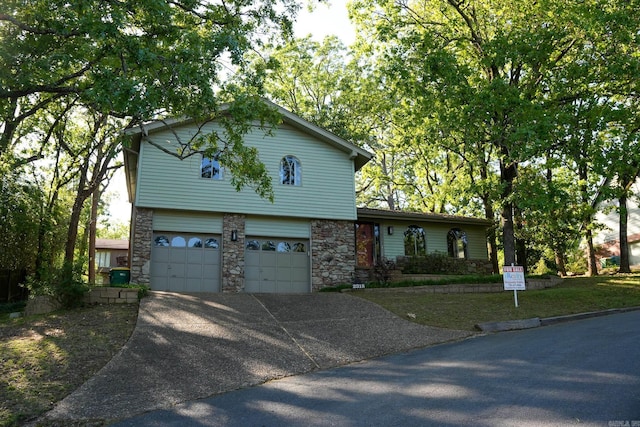 2318 Breckenridge Dr, Little Rock, AR 72227 - view of front of home with stone siding, concrete driveway, and an attached garage