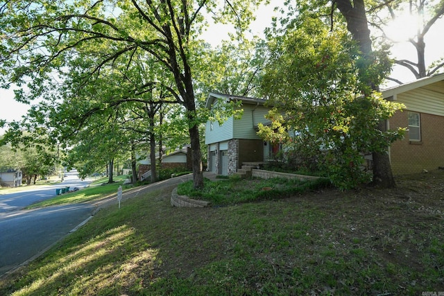 2318 Breckenridge Dr, Little Rock, AR 72227 - view of home's exterior featuring brick siding, an attached garage, and driveway