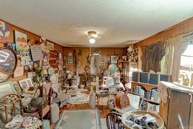 1788 Weatherstone Rd, Mammoth Spring, AR 72554 - living room featuring a textured ceiling, wood walls, and wood finished floors