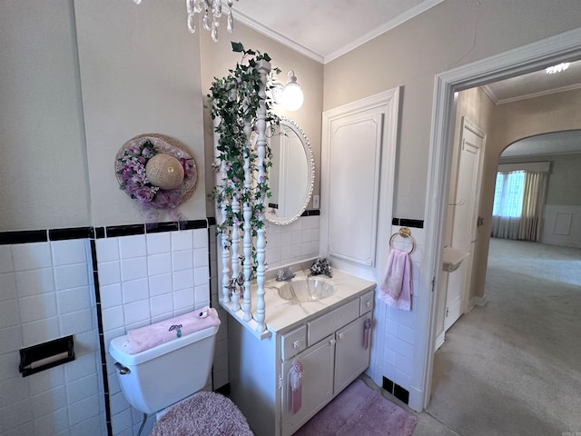 582 N Fourth Ave, Piggott, AR 72454 - bathroom featuring vanity, crown molding, toilet, and tile walls