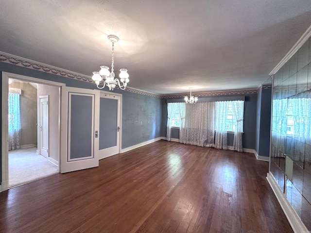 582 N Fourth Ave, Piggott, AR 72454 - spare room with a chandelier, ornamental molding, dark wood-type flooring, and baseboards