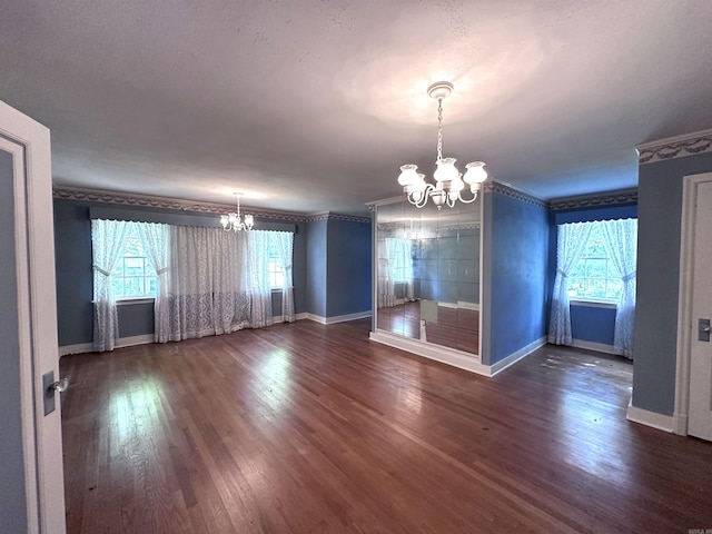 582 N Fourth Ave, Piggott, AR 72454 - empty room with a chandelier, baseboards, wood finished floors, and ornamental molding