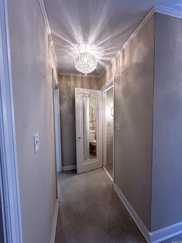582 N Fourth Ave, Piggott, AR 72454 - hall featuring a chandelier, baseboards, crown molding, carpet floors, and a textured ceiling
