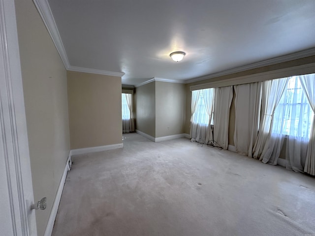 582 N Fourth Ave, Piggott, AR 72454 - empty room featuring crown molding, baseboards, and light colored carpet