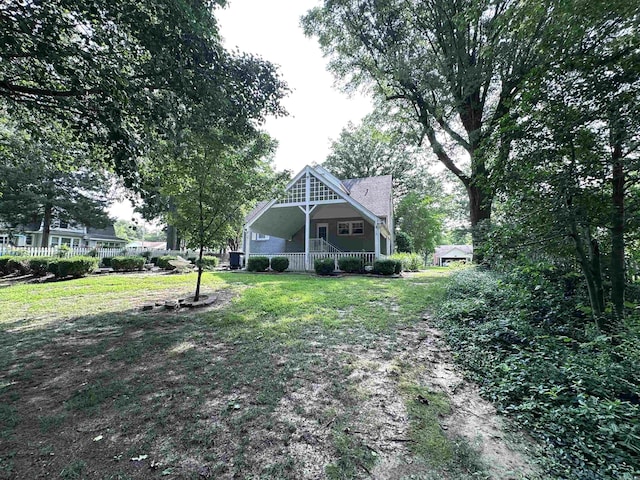 582 N Fourth Ave, Piggott, AR 72454 - back of property with a porch and a lawn