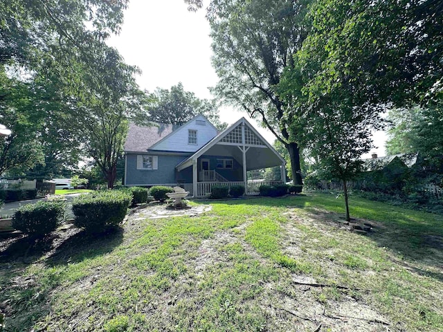 582 N Fourth Ave, Piggott, AR 72454 - rear view of house with a yard