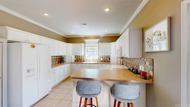 3805 Irby Dr, Conway, AR 72034 - kitchen featuring white appliances, a peninsula, decorative backsplash, white cabinetry, and crown molding