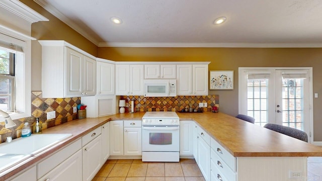 3805 Irby Dr, Conway, AR 72034 - kitchen with white appliances, a peninsula, french doors, crown molding, and light tile patterned floors