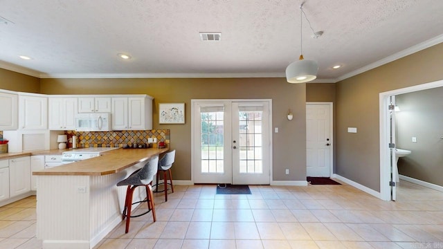 3805 Irby Dr, Conway, AR 72034 - kitchen with white appliances, white cabinets, a peninsula, light countertops, and recessed lighting